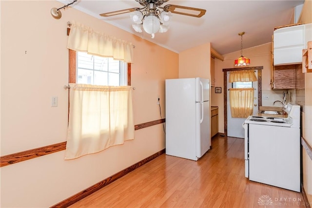 903 Kennison Ave, New Carlisle, OH 45344 - kitchen featuring white appliances, healthy amount of natural light, ceiling fan, light wood finished floors, and vaulted ceiling