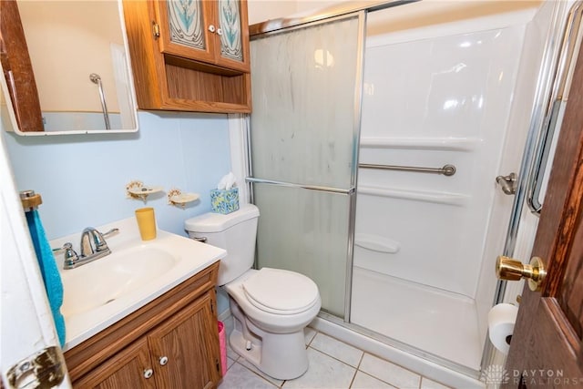 903 Kennison Ave, New Carlisle, OH 45344 - bathroom featuring toilet, a stall shower, tile patterned flooring, and vanity