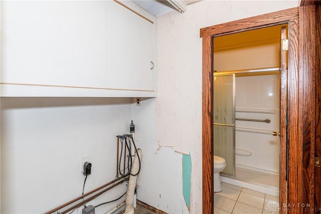 903 Kennison Ave, New Carlisle, OH 45344 - bathroom featuring a stall shower, toilet, and tile patterned flooring