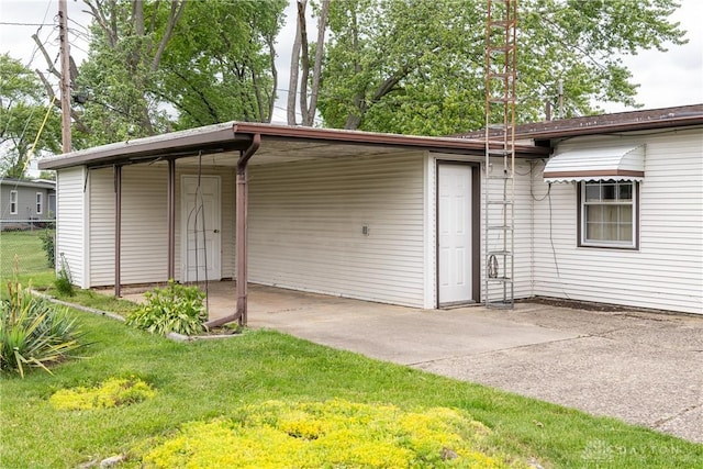 903 Kennison Ave, New Carlisle, OH 45344 - garage featuring an attached carport