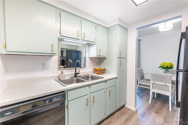 1743 Running Brook Trl Unit C, West Carrollton, OH 45449 - kitchen with dishwasher, a sink, light wood-style flooring, light countertops, and freestanding refrigerator