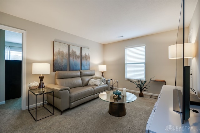 148 Oasis Ct, Springboro, OH 45066 - carpeted living area with plenty of natural light and baseboards