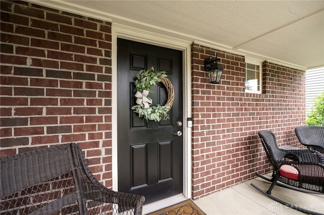 148 Oasis Ct, Springboro, OH 45066 - property entrance with a porch and brick siding