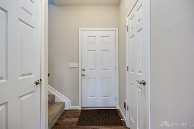 148 Oasis Ct, Springboro, OH 45066 - doorway to outside featuring dark wood-type flooring, baseboards, and stairway