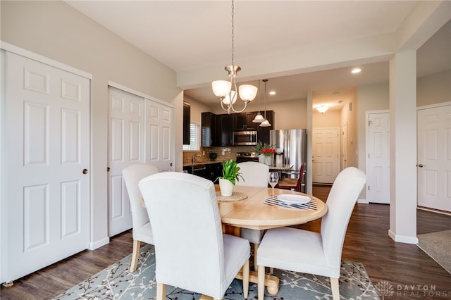 148 Oasis Ct, Springboro, OH 45066 - dining room with dark wood-type flooring, recessed lighting, baseboards, and a chandelier