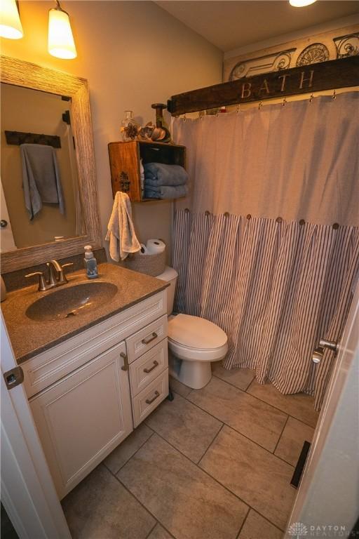 1331 Peregrine Way, Hamilton, OH 45013 - bathroom with vanity, toilet, tile patterned floors, and a shower with curtain
