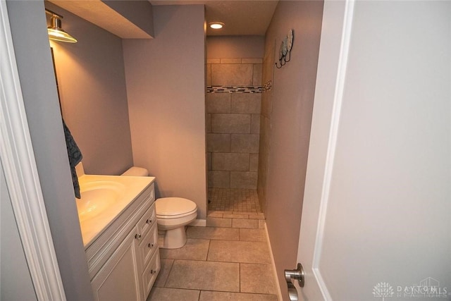 1331 Peregrine Way, Hamilton, OH 45013 - full bath featuring vanity, toilet, a tile shower, tile patterned floors, and baseboards