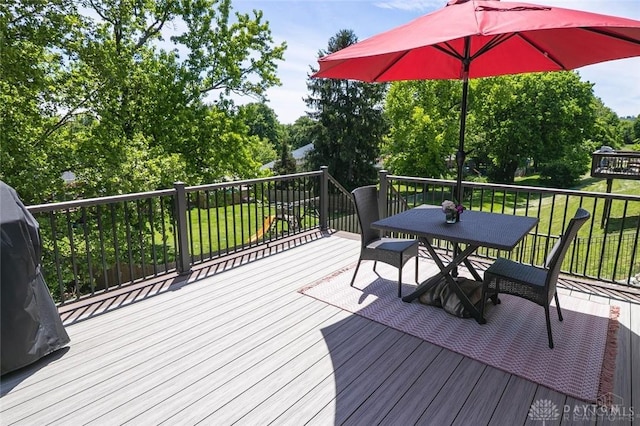 1331 Peregrine Way, Hamilton, OH 45013 - wooden deck with outdoor dining area, a lawn, and view of wooded area