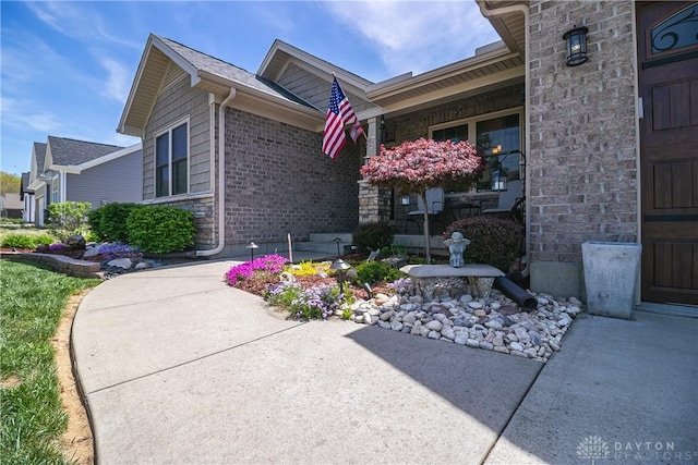 1331 Peregrine Way, Hamilton, OH 45013 - view of property exterior featuring covered porch, brick siding, and stone siding