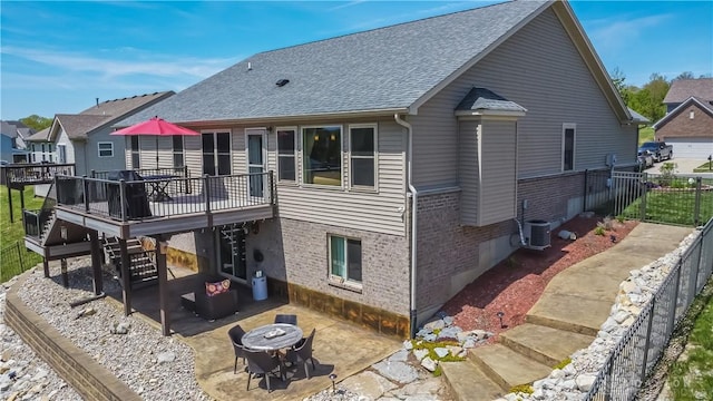 1331 Peregrine Way, Hamilton, OH 45013 - back of property with brick siding, a wooden deck, a patio area, a shingled roof, and stairs