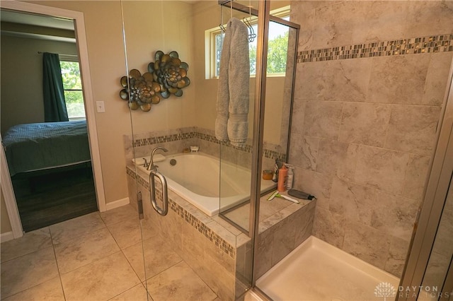 1331 Peregrine Way, Hamilton, OH 45013 - ensuite bathroom featuring a garden tub, a shower stall, tile patterned flooring, and baseboards