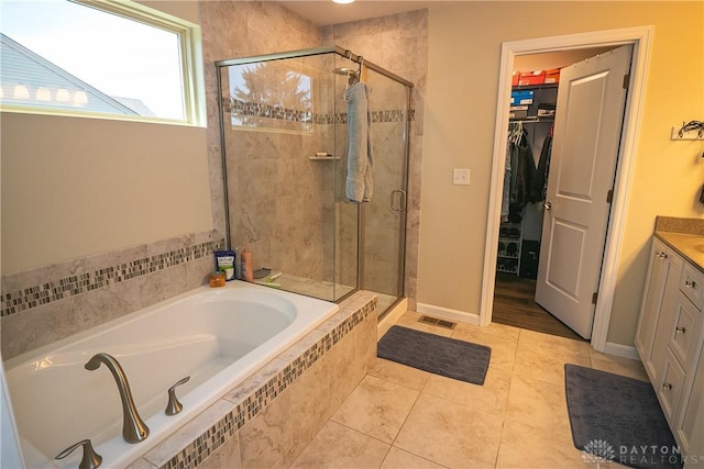 1331 Peregrine Way, Hamilton, OH 45013 - full bathroom with a garden tub, a shower stall, vanity, a walk in closet, and tile patterned floors