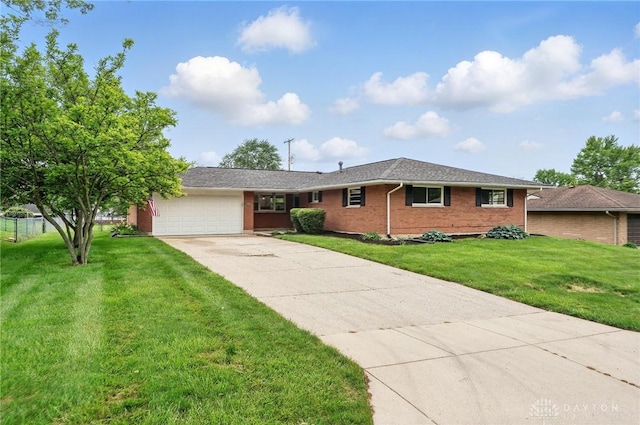 3040 Fontano Dr, Kettering, OH 45440 - ranch-style home featuring an attached garage, driveway, brick siding, and a front lawn