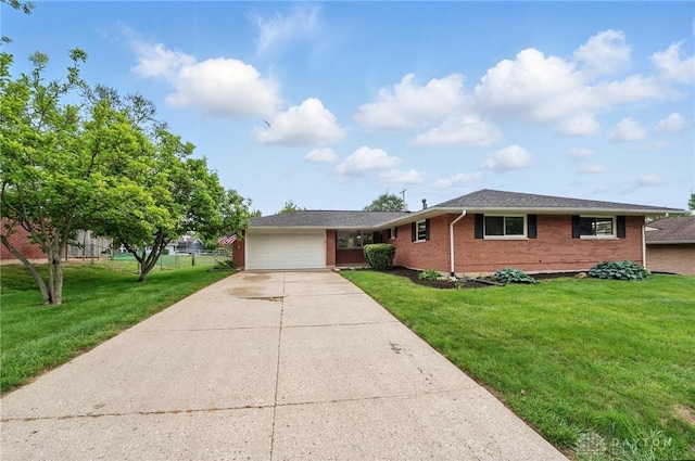 3040 Fontano Dr, Kettering, OH 45440 - ranch-style home with a garage, brick siding, driveway, and a front yard