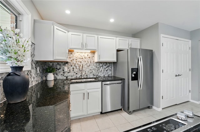 3040 Fontano Dr, Kettering, OH 45440 - kitchen featuring stainless steel appliances, a sink, white cabinets, backsplash, and light tile patterned floors