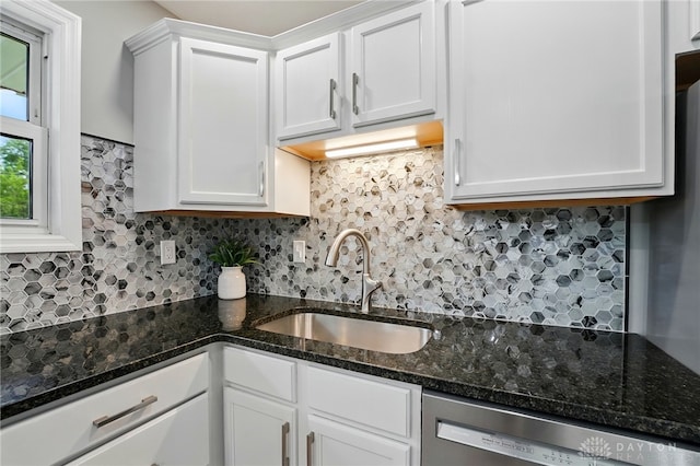 3040 Fontano Dr, Kettering, OH 45440 - kitchen featuring a sink, stainless steel dishwasher, decorative backsplash, white cabinetry, and dark stone countertops