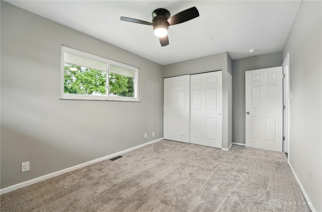 3040 Fontano Dr, Kettering, OH 45440 - unfurnished bedroom featuring carpet flooring, a closet, baseboards, and a ceiling fan