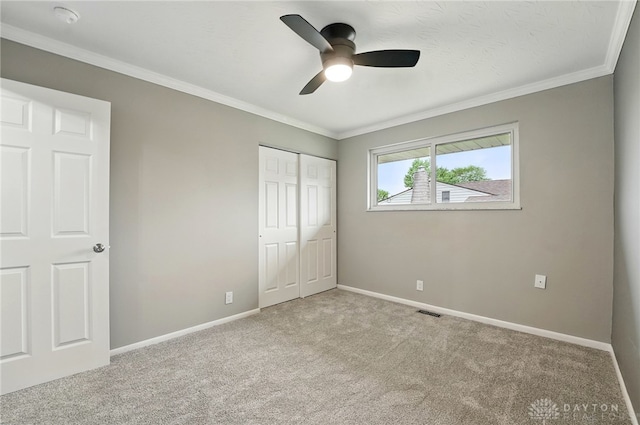 3040 Fontano Dr, Kettering, OH 45440 - unfurnished bedroom with carpet flooring, baseboards, ornamental molding, a closet, and a ceiling fan