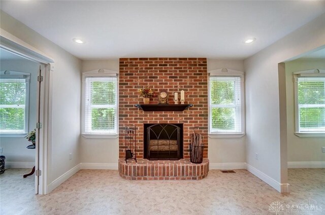 5829 Watt Rd, Camden, OH 45311 - unfurnished living room featuring a brick fireplace, plenty of natural light, carpet, and recessed lighting