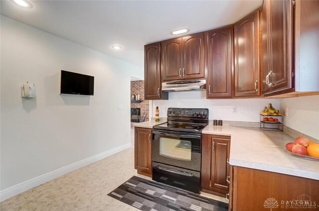 5829 Watt Rd, Camden, OH 45311 - kitchen featuring black range with electric stovetop, under cabinet range hood, light countertops, recessed lighting, and baseboards