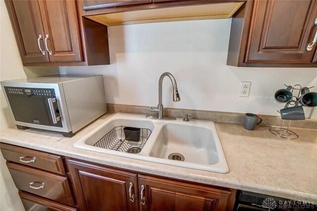 5829 Watt Rd, Camden, OH 45311 - kitchen with a sink, light countertops, black dishwasher, and stainless steel microwave