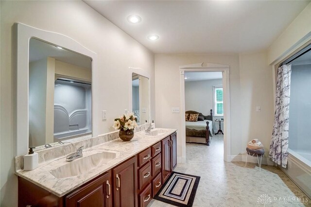 5829 Watt Rd, Camden, OH 45311 - ensuite bathroom with double vanity, a bath, recessed lighting, and baseboards