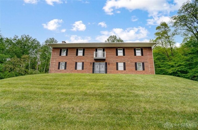 5829 Watt Rd, Camden, OH 45311 - view of front facade featuring a front yard and brick siding