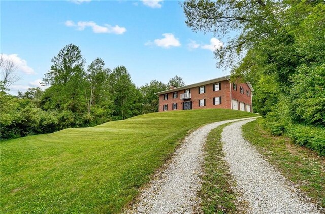 5829 Watt Rd, Camden, OH 45311 - view of front facade featuring driveway, an attached garage, and a front yard