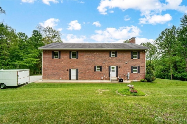 5829 Watt Rd, Camden, OH 45311 - back of house featuring entry steps, a yard, a chimney, central AC, and brick siding