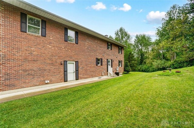 5829 Watt Rd, Camden, OH 45311 - back of house with entry steps, a lawn, and brick siding