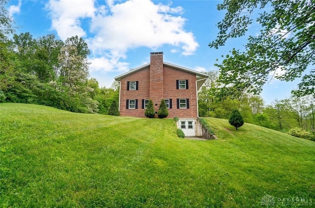 5829 Watt Rd, Camden, OH 45311 - rear view of property with a chimney, a yard, and brick siding