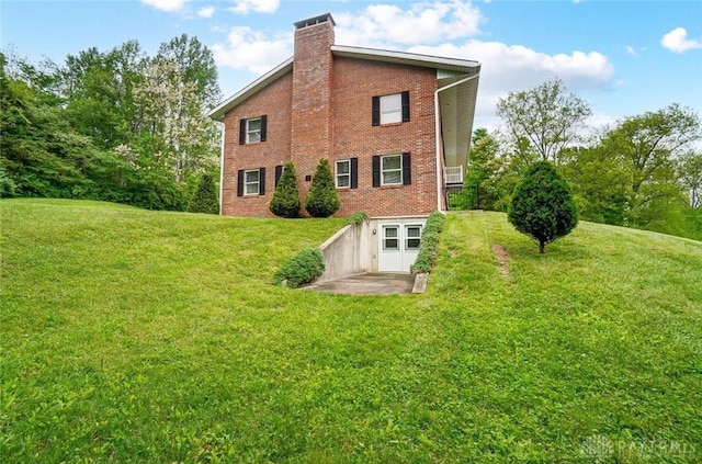 5829 Watt Rd, Camden, OH 45311 - back of house featuring brick siding, a lawn, and a chimney