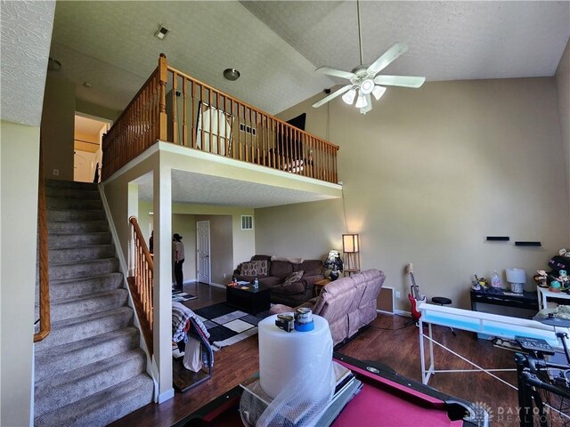 2380 Patterson Ln, Troy, OH 45373 - living area with a ceiling fan, wood finished floors, high vaulted ceiling, baseboards, and stairs