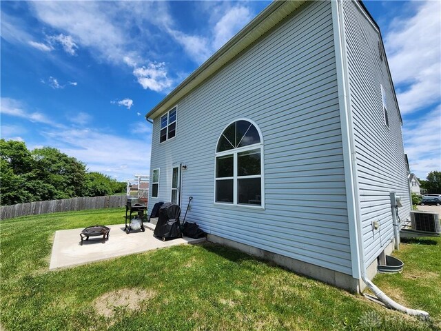 2380 Patterson Ln, Troy, OH 45373 - back of house featuring cooling unit, a patio area, and an outdoor fire pit