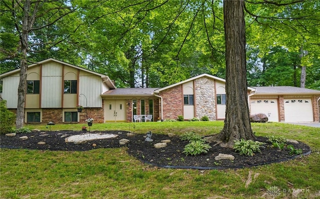 2942 Stauffer Dr, Beavercreek, OH 45434 - split level home with a garage, a front yard, brick siding, and driveway