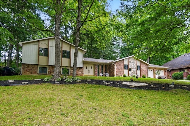 2942 Stauffer Dr, Beavercreek, OH 45434 - view of front of house with brick siding, a front yard, and an attached garage