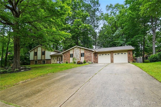 2942 Stauffer Dr, Beavercreek, OH 45434 - tri-level home featuring an attached garage, asphalt driveway, a front lawn, brick siding, and stone siding
