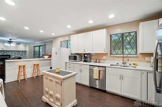 2942 Stauffer Dr, Beavercreek, OH 45434 - kitchen with appliances with stainless steel finishes, a sink, ceiling fan, open floor plan, and dark wood-style flooring