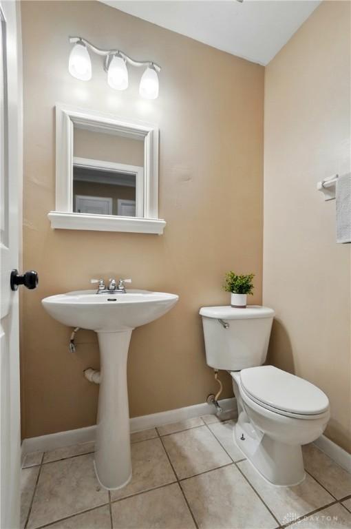 2942 Stauffer Dr, Beavercreek, OH 45434 - bathroom with toilet, tile patterned floors, baseboards, and a sink