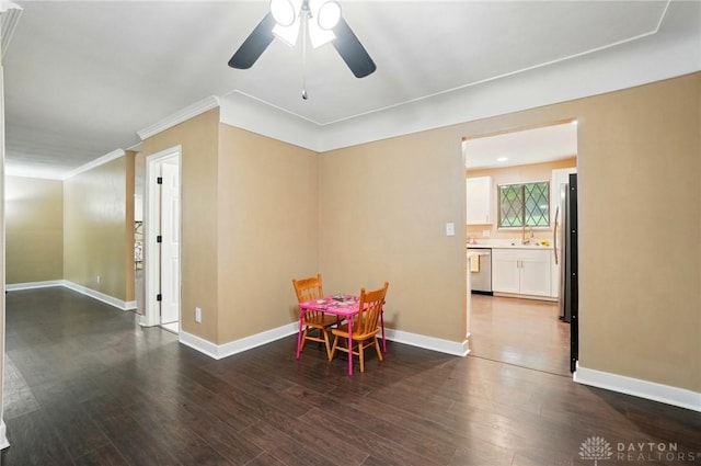 2942 Stauffer Dr, Beavercreek, OH 45434 - dining space featuring a ceiling fan, baseboards, wood finished floors, and crown molding