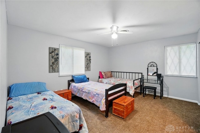 2942 Stauffer Dr, Beavercreek, OH 45434 - carpeted bedroom with multiple windows and a ceiling fan