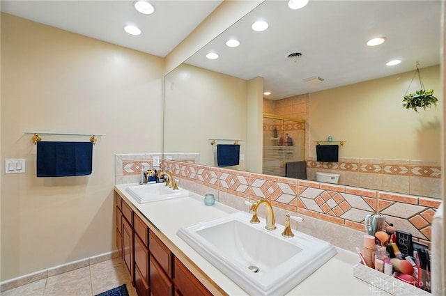 2942 Stauffer Dr, Beavercreek, OH 45434 - full bathroom with recessed lighting, double vanity, a stall shower, tile patterned floors, and backsplash