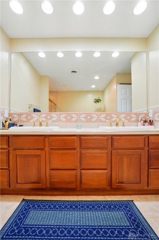 2942 Stauffer Dr, Beavercreek, OH 45434 - bathroom featuring double vanity, backsplash, and recessed lighting