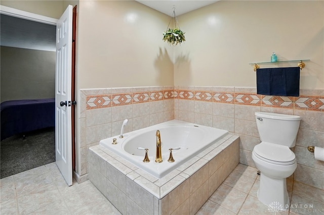 2942 Stauffer Dr, Beavercreek, OH 45434 - ensuite bathroom featuring a bath, tile patterned floors, toilet, and a wainscoted wall