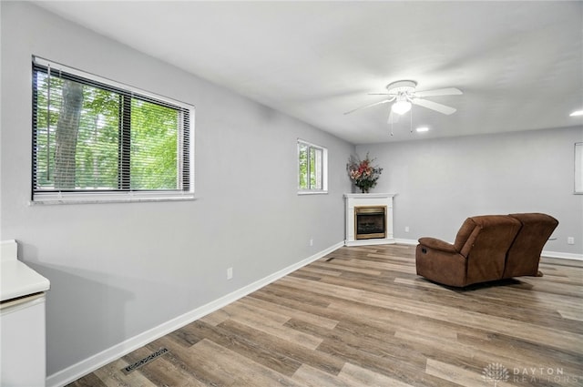 2942 Stauffer Dr, Beavercreek, OH 45434 - living area featuring wood finished floors, ceiling fan, a fireplace, and baseboards
