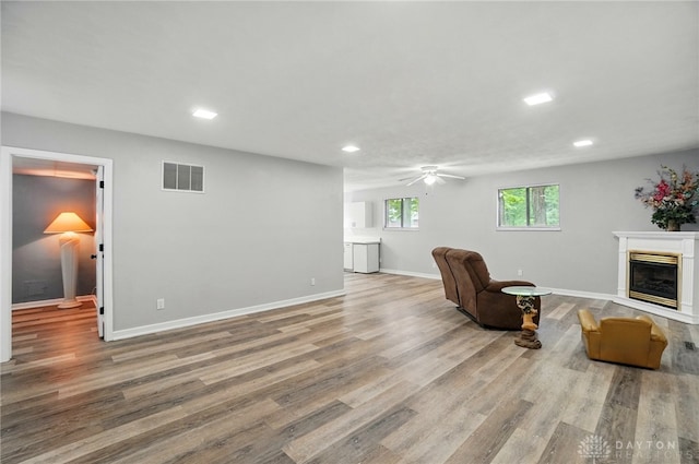2942 Stauffer Dr, Beavercreek, OH 45434 - sitting room with ceiling fan, recessed lighting, a glass covered fireplace, wood finished floors, and baseboards