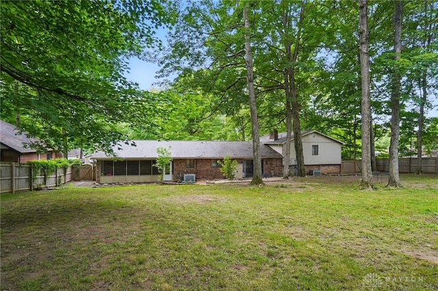2942 Stauffer Dr, Beavercreek, OH 45434 - rear view of house featuring a sunroom and central AC
