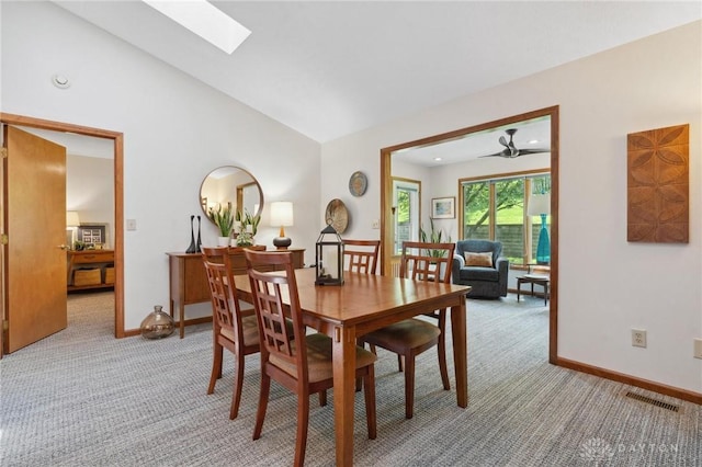 1462 Dee Anne Dr, Xenia, OH 45385 - dining area with light colored carpet, baseboards, a skylight, and lofted ceiling