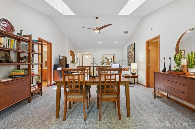 1462 Dee Anne Dr, Xenia, OH 45385 - dining area featuring a skylight, light carpet, ceiling fan, high vaulted ceiling, and baseboards