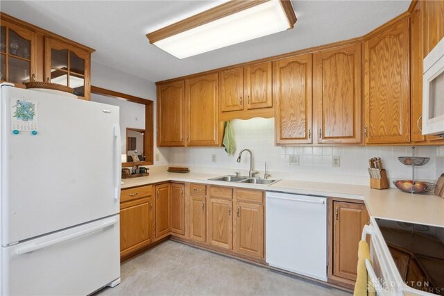 1462 Dee Anne Dr, Xenia, OH 45385 - kitchen with white appliances, a sink, backsplash, light countertops, and brown cabinetry